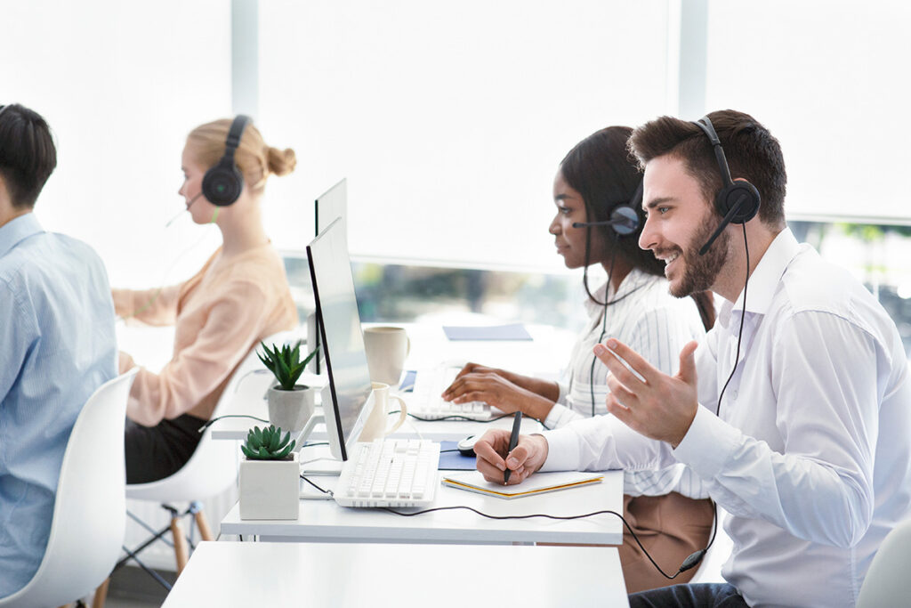 Customer Service representatives assisting clients via Voice Over IP headsets.